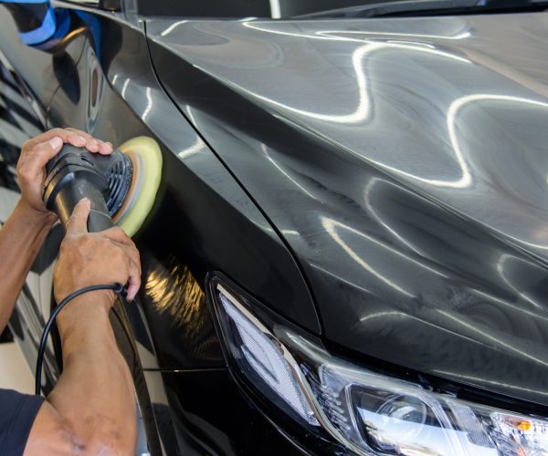 Car detailing.Man hand holding and polish the car.